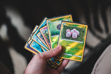 set of pokemon cards in hand